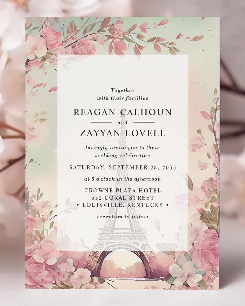 Wedding invitation for Reagan Calhoun and Zayyan Lovell, featuring a watercolor Eiffel Tower and floral design.