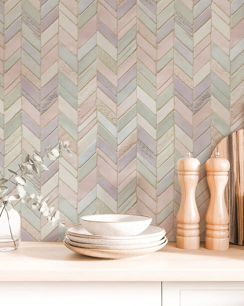 Pastel chevron patterned backsplash with kitchenware in front.