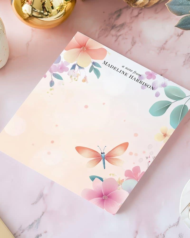 Floral notepad with a dragonfly and Madeline Harrison's name.