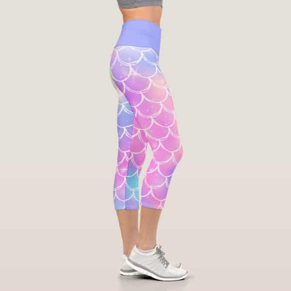 Woman'S Legs Wearing Pastel Mermaid-Scale Patterned Cropped Leggings And White Athletic Shoes.