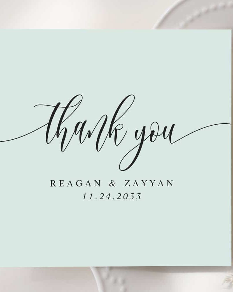 Light blue thank you card with elegant script lettering. The names Reagan & Zayyan and the date 11.24.2033 are also included.