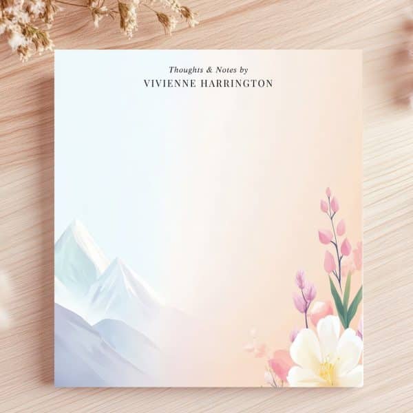 Personalized Notepad Featuring A Mountain Range On The Left And Pink Flowers On The Right.