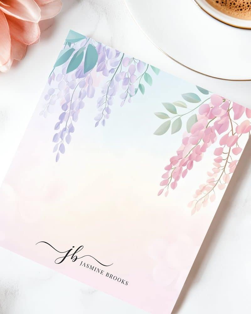 Pastel pink and purple wisteria flowers on a stationery card with the initials JB and Jasmine Brooks.