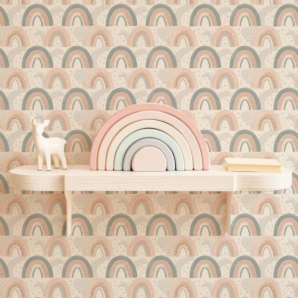 Pastel Rainbow Stacking Toy And Small Deer Figurine On A Shelf Against A Rainbow Patterned Wall.