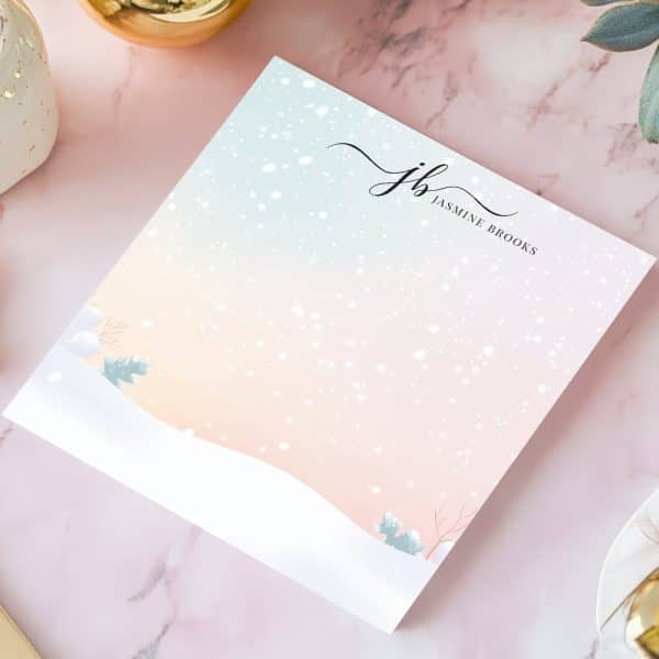 Winter-Themed Notepad With A Pastel Background, Snowflakes, And A Minimalist Snowy Landscape. The Initials Jb And Jasmine Brooks Are Printed At The Top.