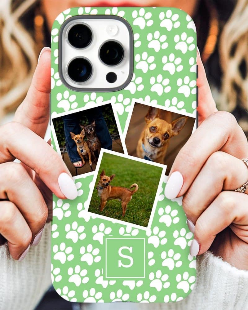 A light green phone case with white paw prints and photos of small dogs; a monogrammed S is in the center.