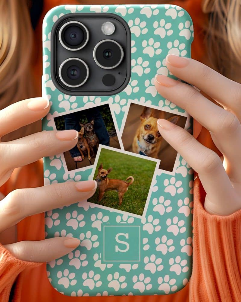 A teal phone case with white paw prints and personalized photos of small dogs is held by a person.
