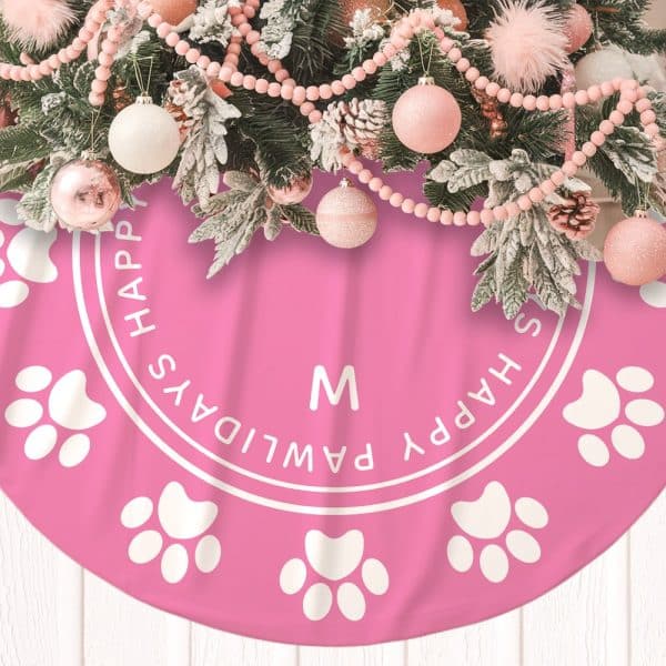 Pink Christmas Tree Skirt With White Paw Prints And The Phrase Happy Pawlidays.