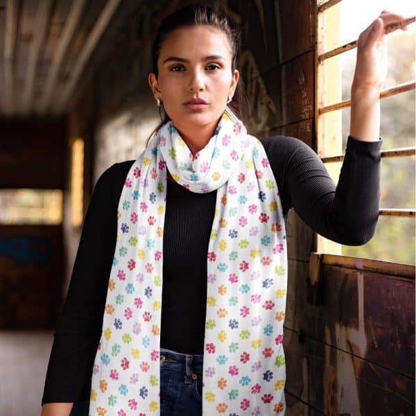 Woman Wearing A White Scarf With Multicolored Paw Prints.