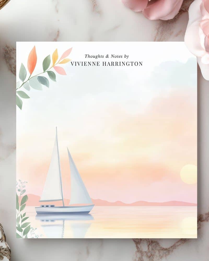 Sailboat at sunset on notepad with author's name.