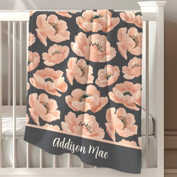 Personalized Baby Blanket With A Gray Background And A Repeating Pattern Of Peach-Colored Poppies. The Name Addison Mae Is Embroidered At The Bottom.