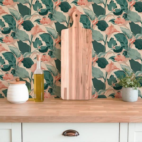Wooden Cutting Board In Front Of Peach And Green Floral Wallpaper.