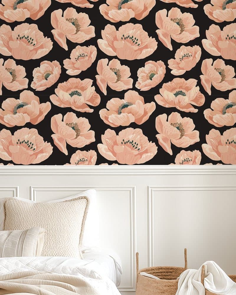 Peach-colored floral wallpaper on a black background.