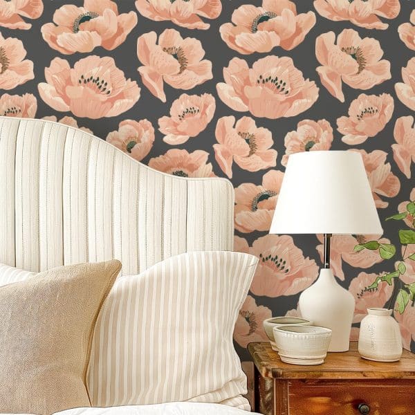 A Bed With Beige Striped Pillows Against A Wall With A Floral Wallpaper Featuring Peach-Colored Poppies On A Dark Gray Background.