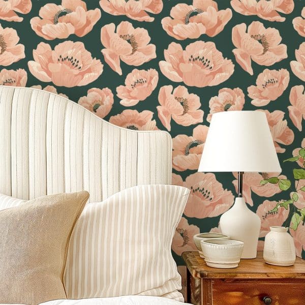 A Bedroom Headboard And Pillows Against A Wall With A Dark Green Floral Wallpaper Featuring Large Peach-Colored Poppies.