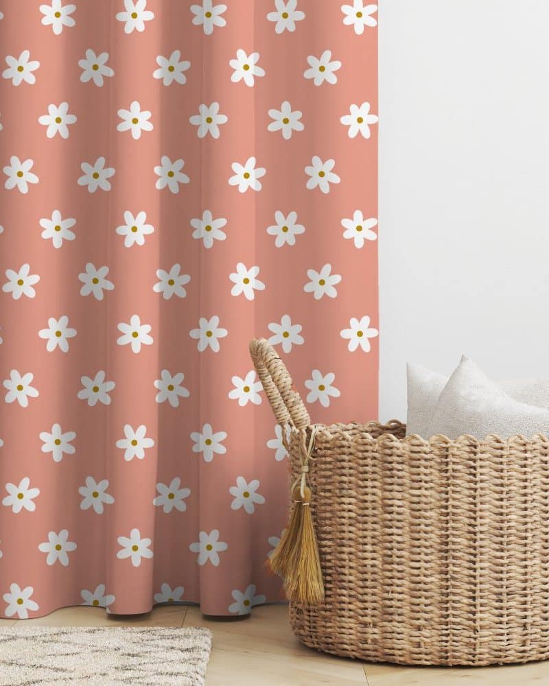 Peach curtain with a repeating pattern of white daisies.