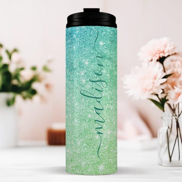 Personalized Teal And Green Glitter Tumbler With The Name Madison.