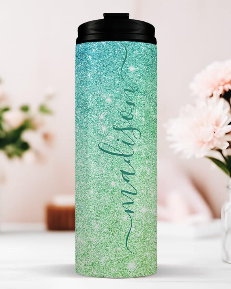 Personalized teal and green glitter tumbler with the name Madison.