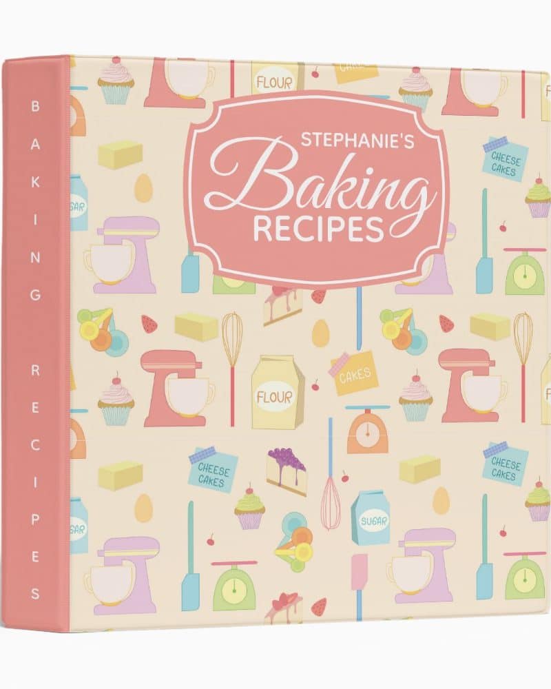 A pink binder labeled Stephanie's Baking Recipes, featuring a pastel pattern of baking-related illustrations.