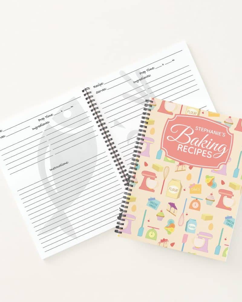 Spiral-bound baking recipe book with a pastel cover featuring baking-themed illustrations and the owner's name. A blank recipe template is also shown.