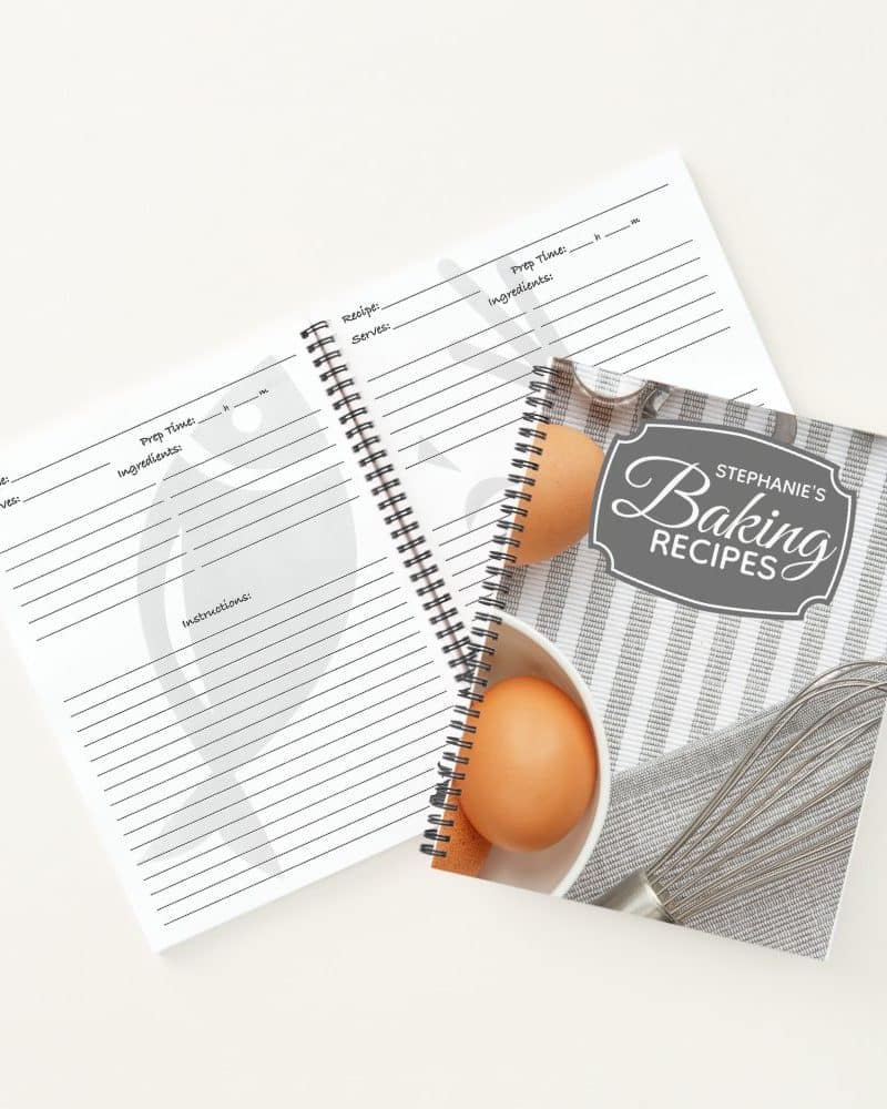 A spiral-bound baking recipe book with blank recipe pages and a cover featuring eggs and a whisk.