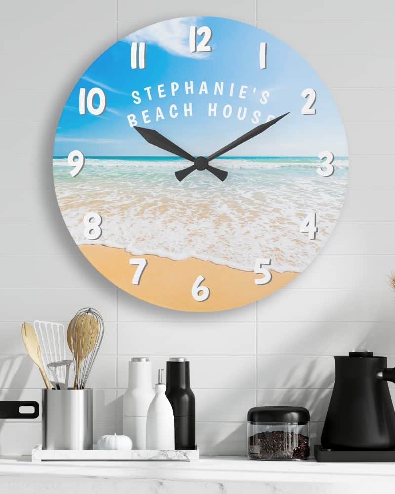 Round beach scene clock with personalized text.