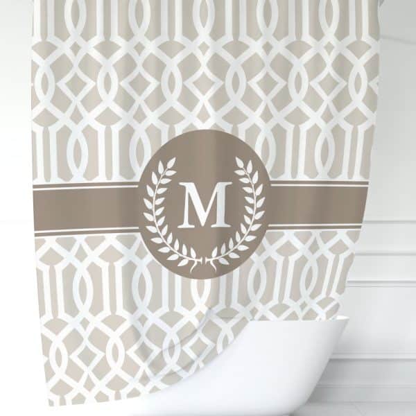 Beige Shower Curtain With A Geometric Pattern And A Brown Circle Monogram Featuring The Letter M.