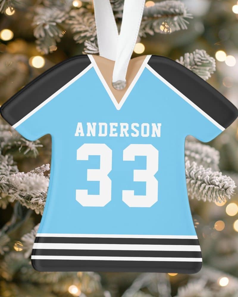 Light blue jersey-shaped Christmas ornament with the name Anderson and number 33.