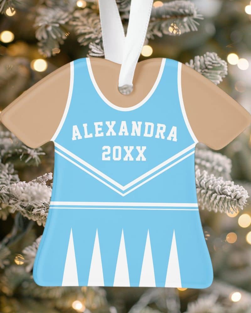 Light blue and tan cheerleader uniform-shaped Christmas ornament with the name Alexandra and the year 20XX.