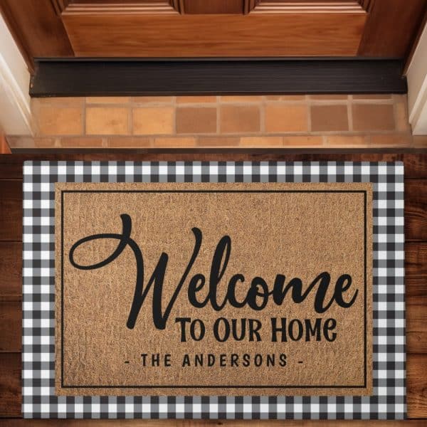 A Welcome Mat With A Black And White Buffalo Check Border. The Mat Says Welcome To Our Home, The Andersons.
