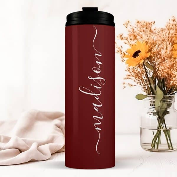 Burgundy Travel Tumbler With The Name Madison In A Script Font.