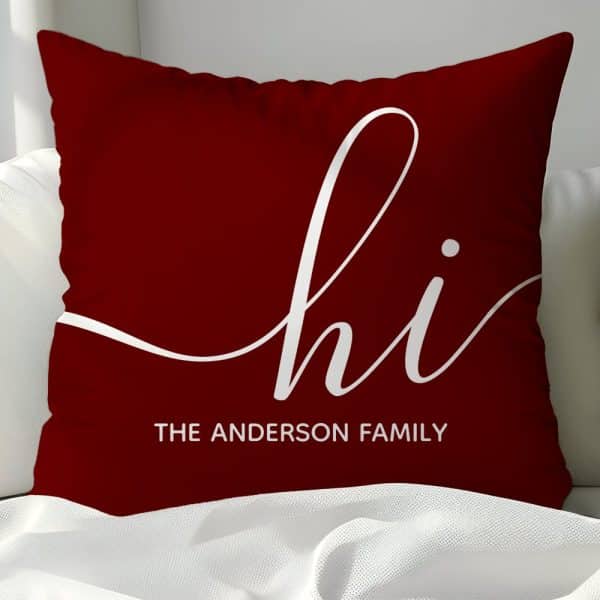 Burgundy Throw Pillow With White Script Lettering That Says Hi And The Anderson Family Below.