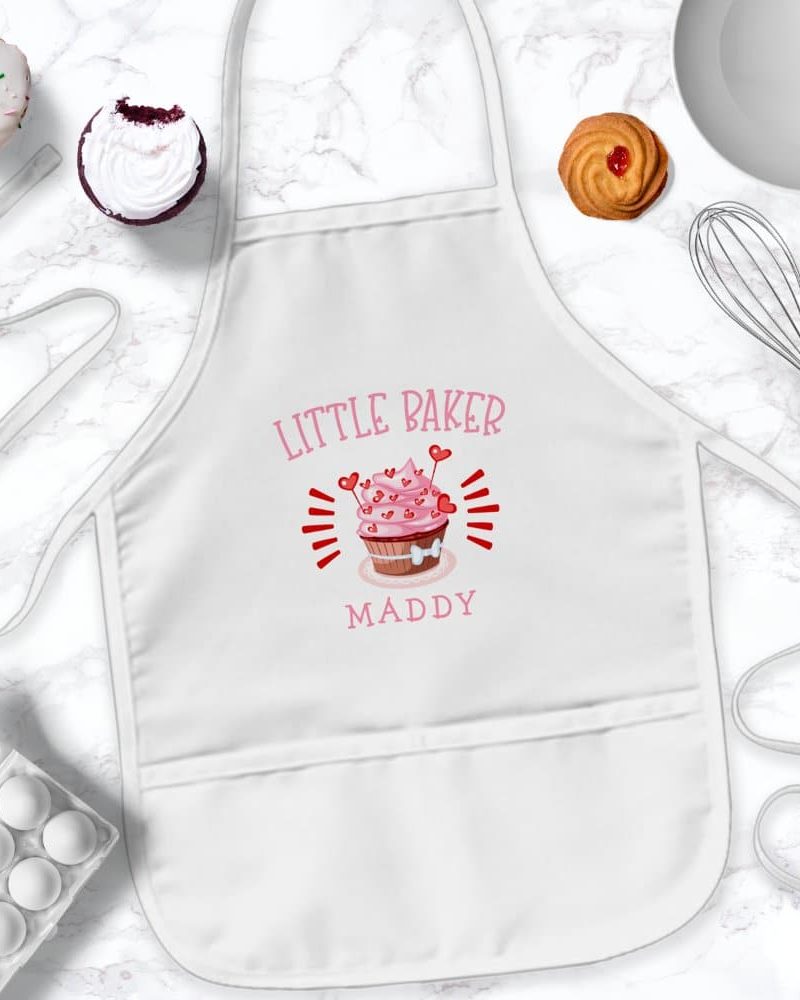 White child's apron with pink cupcake design and the name Maddy.