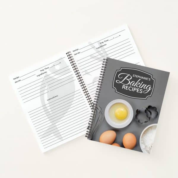 A Spiral-Bound Baking Recipe Book With Blank Recipe Pages Lying Open Beside It.