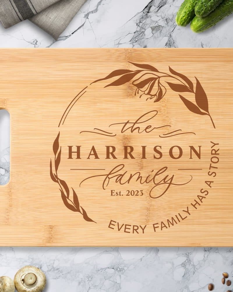 Personalized bamboo cutting board with the Harrison family name, established date 2023, and a floral design.