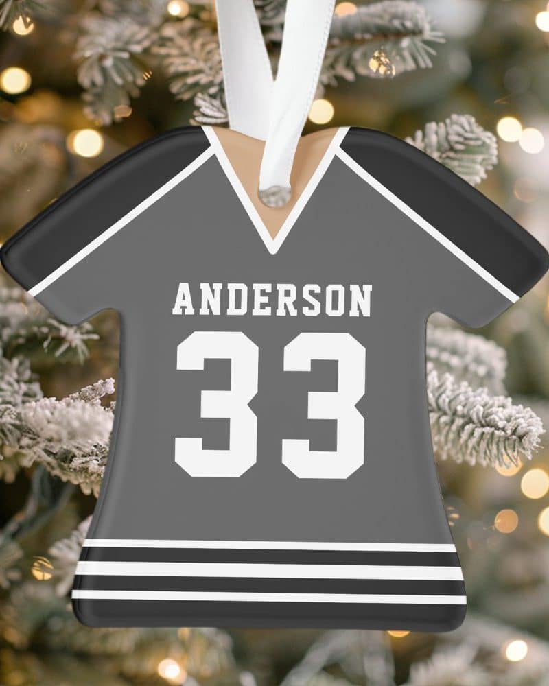 Gray jersey-shaped Christmas ornament with the name Anderson and number 33.