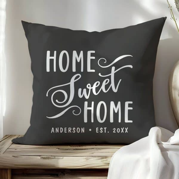 Dark Gray Throw Pillow With The Text Home Sweet Home In A Stylized White Script Font. A Personalized Name And Date Are Also Included.