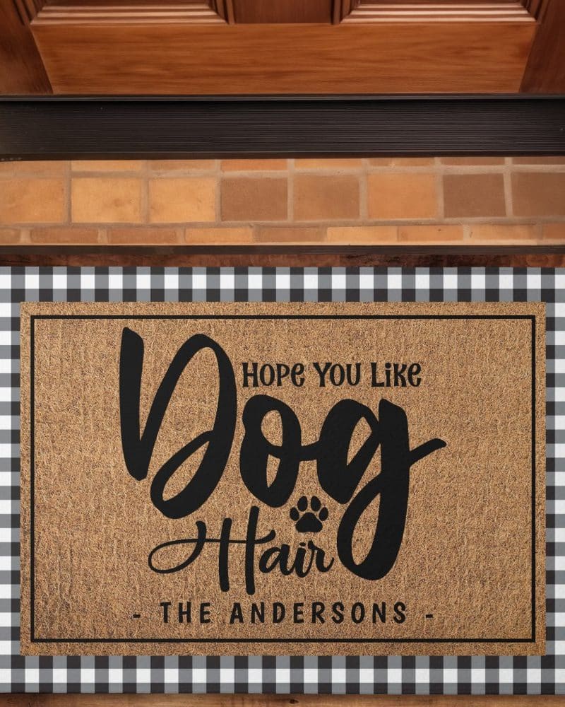Coir doormat with black and white buffalo check border; the mat says Hope You Like Dog Hair, The Andersons.