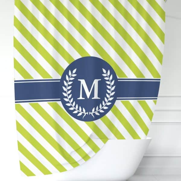 Lime Green And White Diagonal Striped Shower Curtain With A Navy Blue Circle Monogram Featuring The Letter M, Framed By A Laurel Wreath.