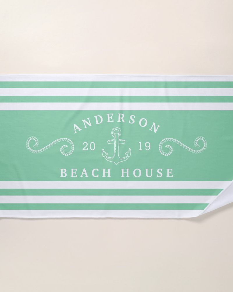 Mint green and white striped beach towel with the Anderson Beach House logo, featuring an anchor and the numbers 20 and 19.