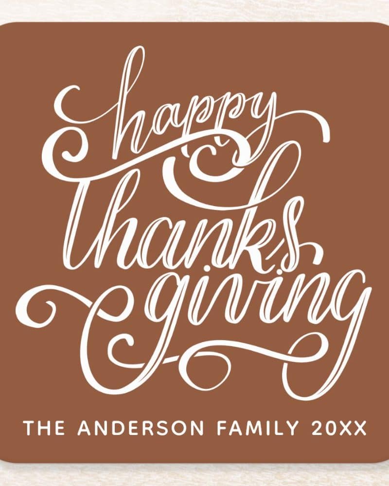 Brown Thanksgiving card with white script that says Happy Thanksgiving, and the Anderson family name and year at the bottom.