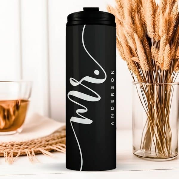 Black Travel Tumbler With The Word Mrs And A Last Name, Anderson, In A Stylized White Script.
