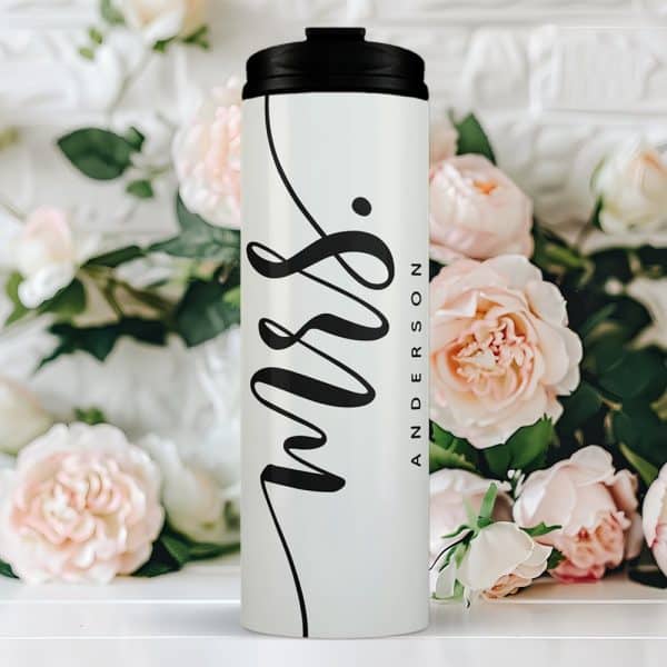 White Travel Mug With Black Lid And The Word Mrs. And A Name In Elegant Script.