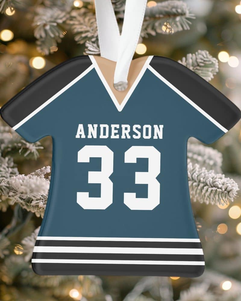 Personalized teal hockey jersey Christmas ornament with the name Anderson and number 33.