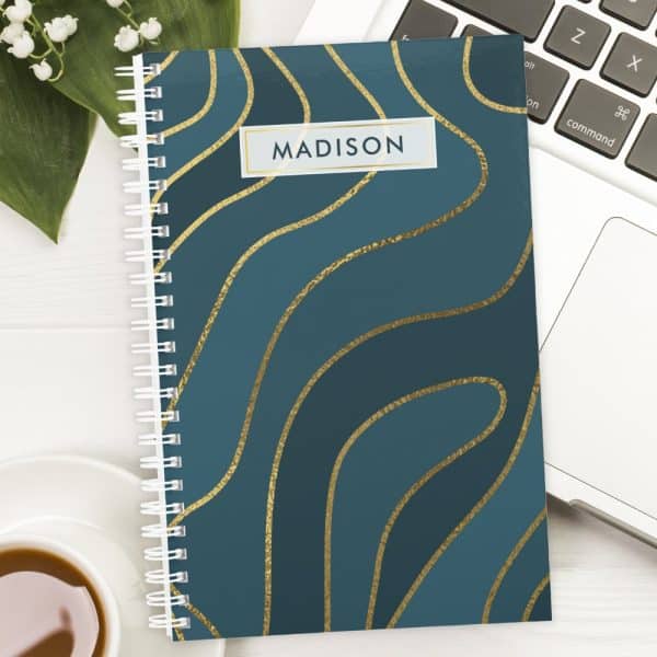 Teal Spiral Notebook With Gold Wavy Lines And The Name Madison On The Cover.
