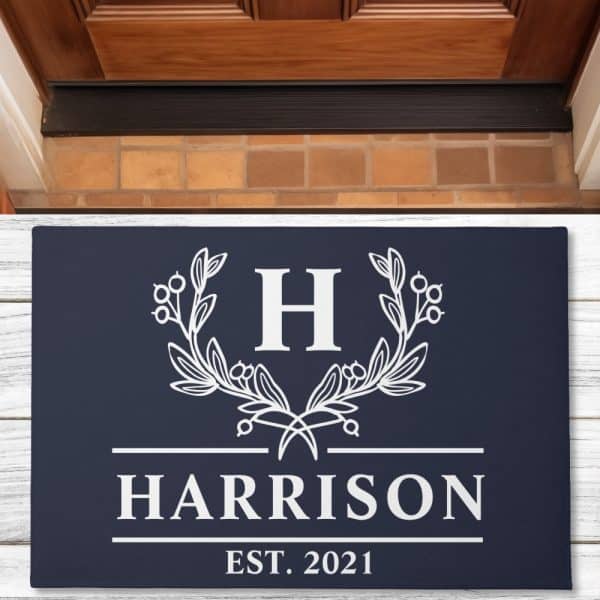 Navy Blue Doormat With A White Monogram Featuring The Letter H Surrounded By An Olive Branch Wreath, The Name Harrison, And Established 2021.