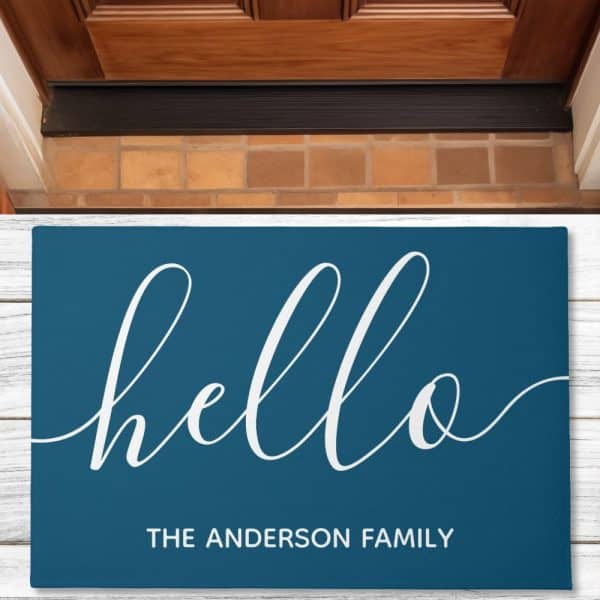 Teal Welcome Mat With The Word Hello In A White Script Font And The Text The Anderson Family Below.