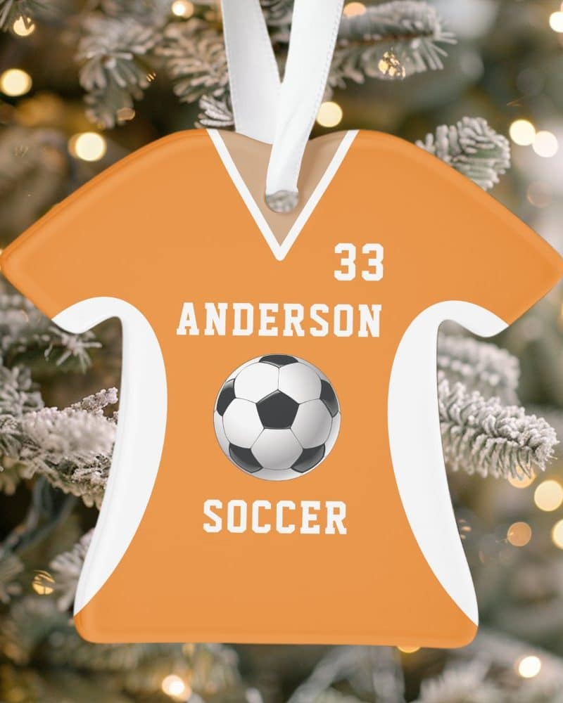 Orange soccer jersey-shaped Christmas ornament with the name Anderson and number 33, a soccer ball, and the word soccer.