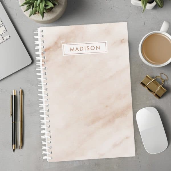 Spiral-Bound Notebook With A Marble Design And The Name Madison On The Cover.