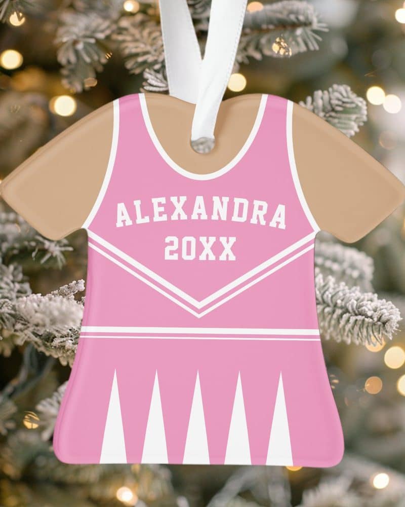 Pink cheerleader uniform-shaped Christmas ornament with the name Alexandra and the year 20XX.